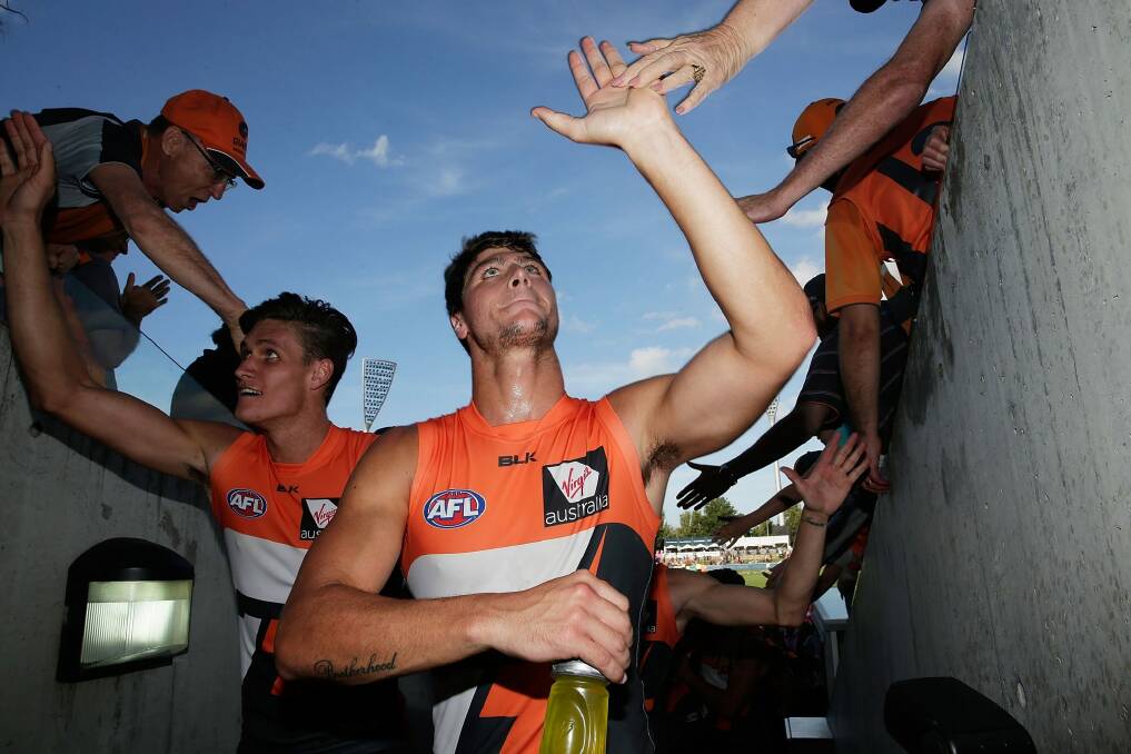 GWS Giants forwards Jonathon Patton and Rory Lobb celebrate with fans after victory against Geelong at Manuka Oval this year. Photo: Getty Images