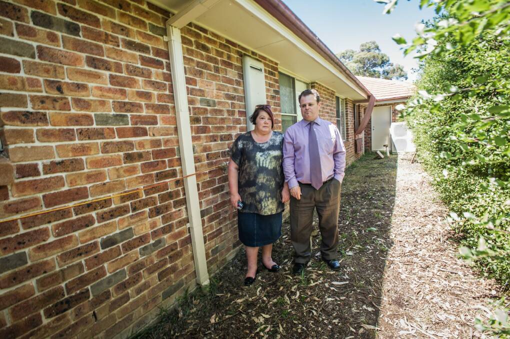 Macquarie couple Greg and Melissa Wilson are worried about asbestos contamination after flash floods from the neighbouring Mr Fluffy block bought torrents of water and debris into their yard. Pictured in the area that was under water during the floods.  Photo: karleen minney