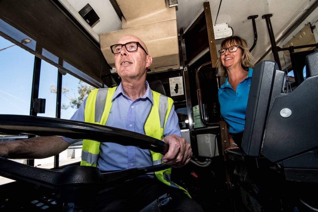 Whoops! Steve Evans takes the wheel of a Canberra bus guided by driver, Karan Kenny. Photo: Karleen Minney