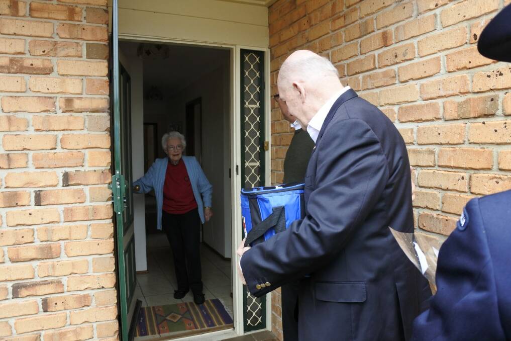 Meals on Wheels client Norma Steele was greeted by Governor-General Sir Peter Cosgrove who delivered her two meals and a bunch of flowers for her birthday. Photo: Clare Sibthorpe