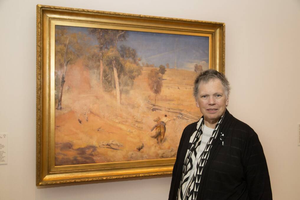 Irony: Dr Anna Gray with the Tom Robert's painting A Break Away! Photo: Supplied
