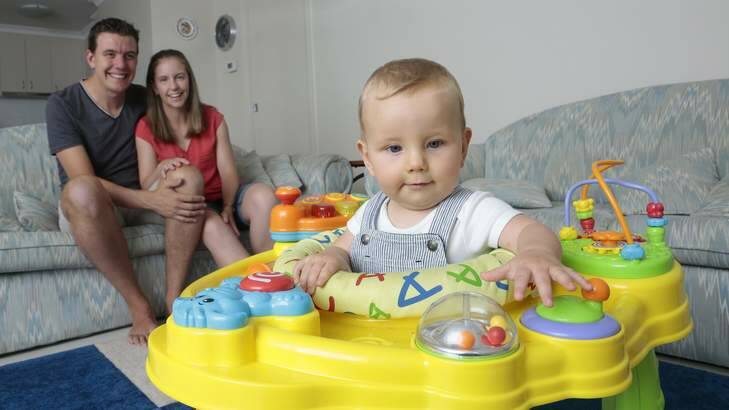 Matt Caldow and Mel Caldow playing with their son Alexander Caldow, 9 months, at their Casey home. Photo: Jeffrey Chan