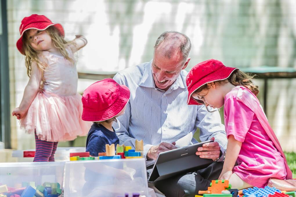Professor Tom Lowrie of the University of Canberra's STEM Education Research Centre plays with children from the Wiradjuri Pre-school.  Photo: Karleen Minney