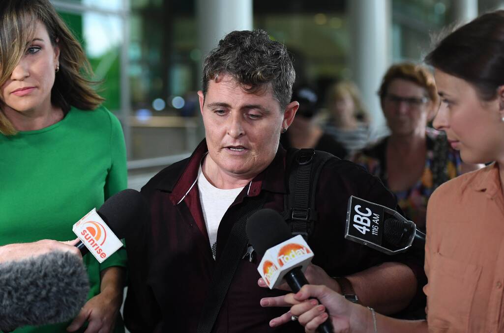 Ms Lawrence barely spoke as she touched down to waiting media at Brisbane Airport on Thursday. Photo: AAP