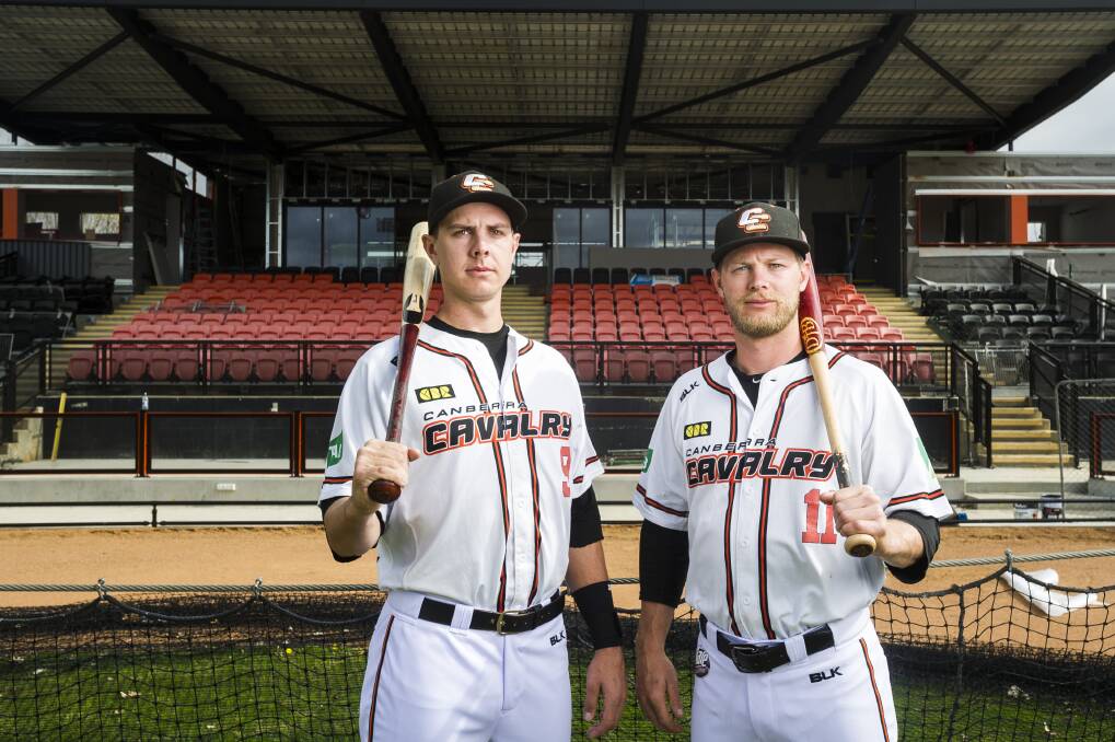 Canberra Cavalry players Robbie Perkins and Kyle Perkins in front of the redeveloped grandstand. Photo: Dion Georgopoulos