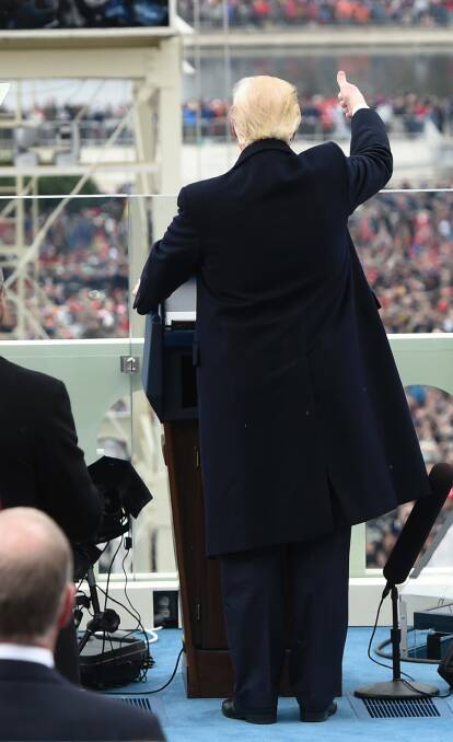 President Donald Trump acknowledges the crowd during the presidential inauguration on Capitol Hill. Photo: SAUL LOEB