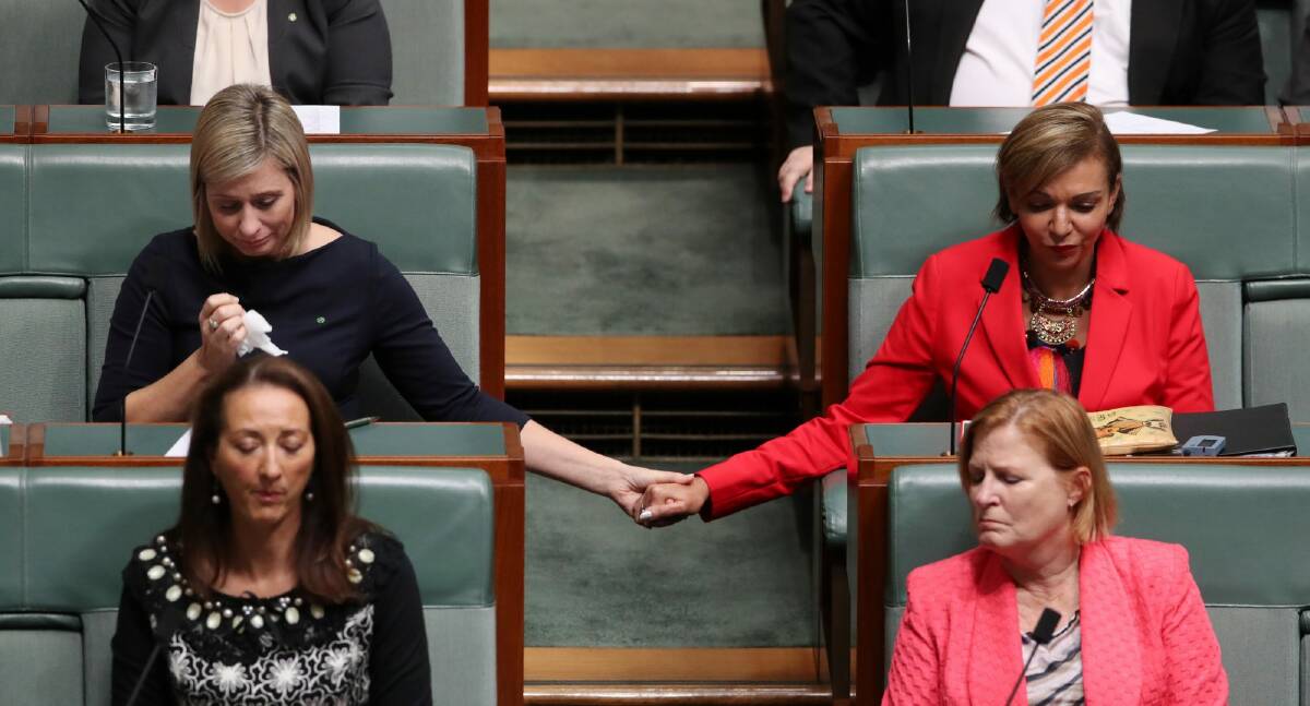 Susan Lamb holds hands with Anne Aly as Bill Shorten talks about the death of Binni Kirkbright-Burney, the son of Linda Burney. Photo: Andrew Meares