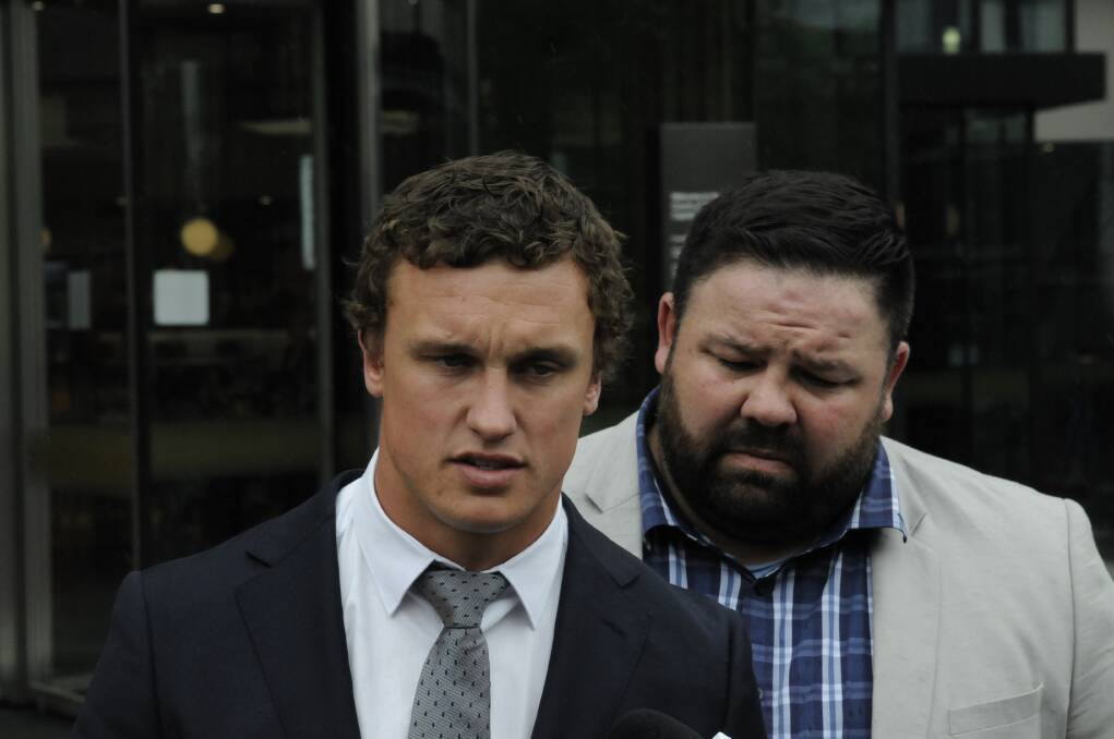 Canberra Raiders fullback Jack Wighton (left), supported by former NRL player George Rose apologises for his behaviour outside ACT courts on Wednesday. Photo: Michael Inman