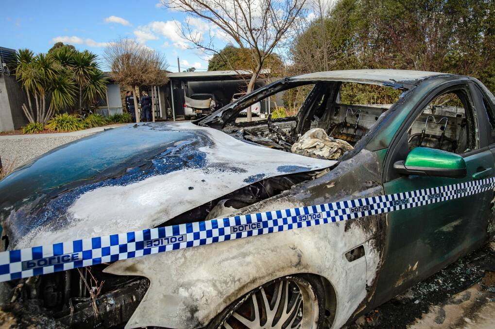 Police examine a property in Kambah after shots were fired and vehicles set alight on Friday morning in what police are describing as the latest incident in an ongoing bikie feud. Photo: Sitthixay Ditthavong Photo: Sitthixay Ditthavong