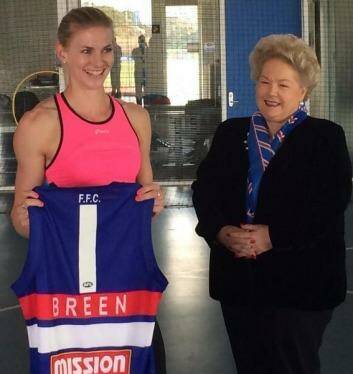 Australian sprint champion Melissa Breen gets presented with a jersey from Western Bulldogs vice-president Sue Alberti, who has donated money for Breen's training. Photo: Supplied