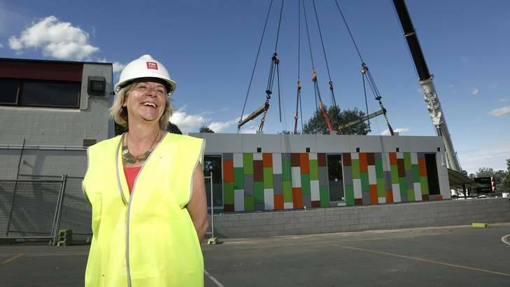 A delighted principal Kim Darcy after one of the ten classroom modules to be lifted is put into place at Duffy Primary School as part of a $2.8 million upgrade at the school. Photo: Jeffrey Chan