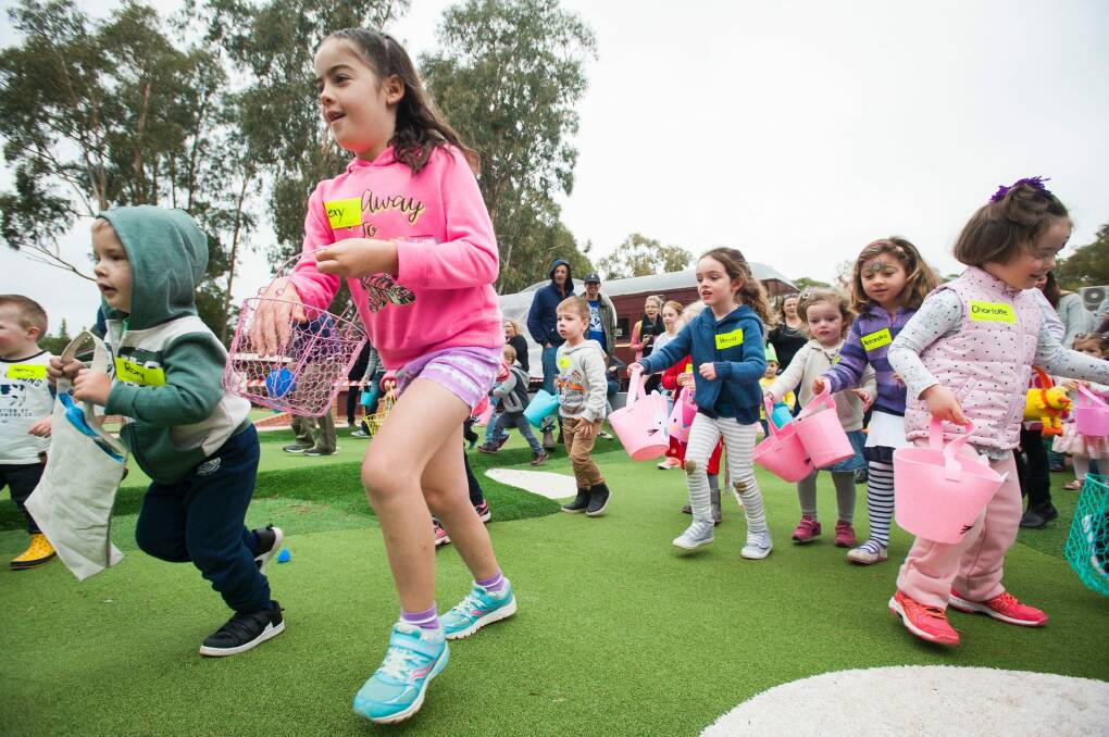 Children and parents frantically start running as the egg hunt begins. Photo: Dion Georgopoulos