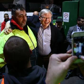 Say cheese: Kevin Rudd with employees at the Flemington Fruit Market. Photo: Andrew Meares
