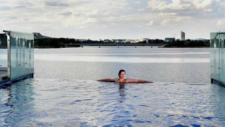 Catriona Rafael enjoys a dip in the infinity edge pool at the Lakefront Kingston Island apartment. Photo: Melissa Adams