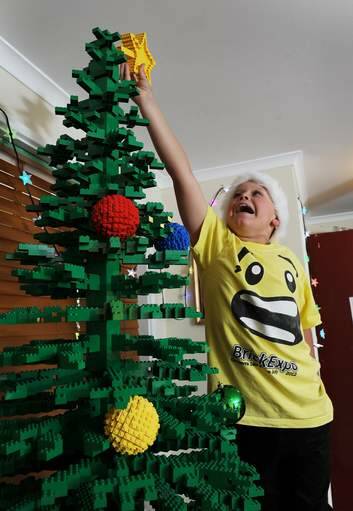 Oliver McLauchlan, 9, gives his LEGO tree the finishing touch. Photo: Colleen Petch