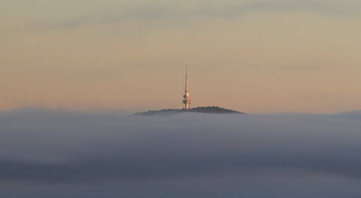 Low lying fog seen from Jerrabomberra in autumn. Black Mountain tower pierces the fog on the horizon. Photo: Graham Tidy