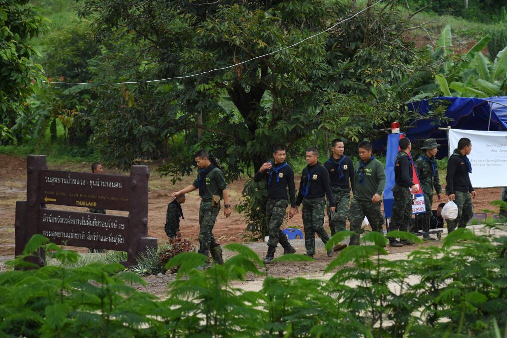Thai rescue volunteers return from the base camp near Tham Luang cave on day two of the rescue operation. Photo: Kate Geraghty