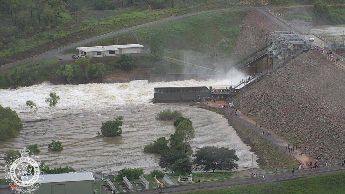 Water flows out of the Ross River Dam in Townsville after the floodgates were opened on Sunday night Photo: QFES