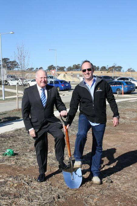 Planning Minister Mick Gentleman and Kirk Coningham from the Master Builders Association turn a sod at Moncrieff in November 2014.  Photo: Supplied