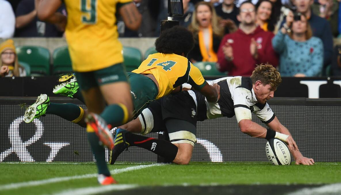 Queensland-bound flanker Adam Thomson scores in the corner for the Barbarians. Photo: Getty Images