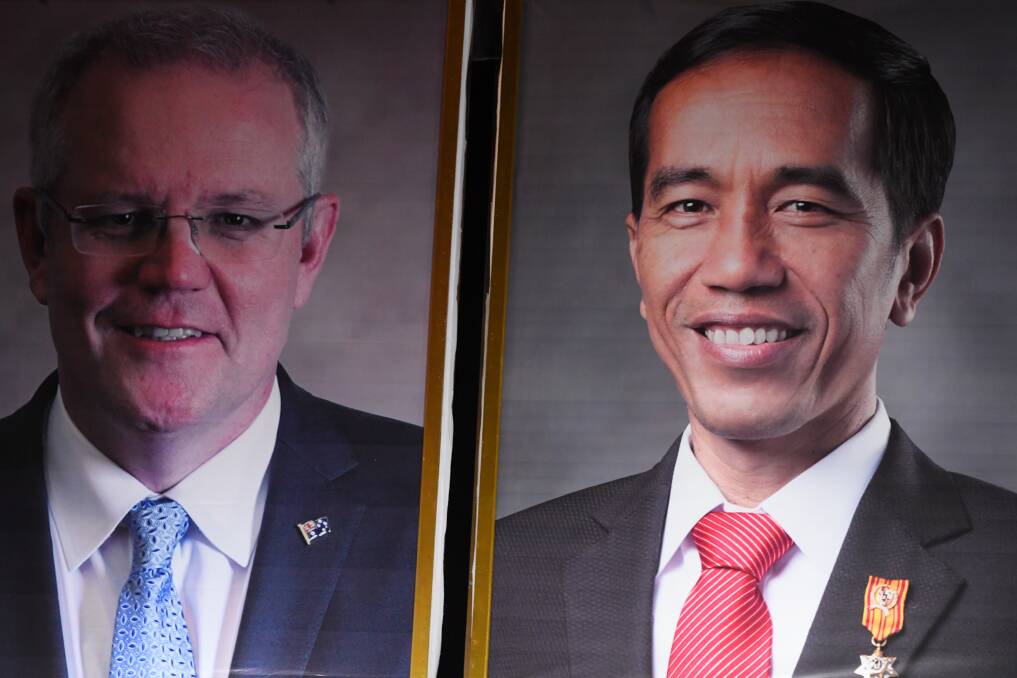 Concluding a trade deal: posters of Australian Prime Minister Scott Morrison (left) and Indonesian President Joko Widodo. Photo: AAP