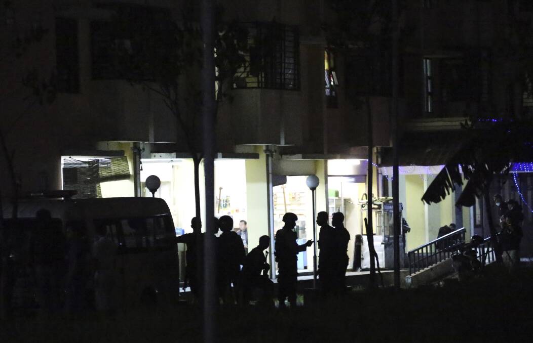 Indonesian police stand guard in front of an apartment building after an explosion.  Photo: AP