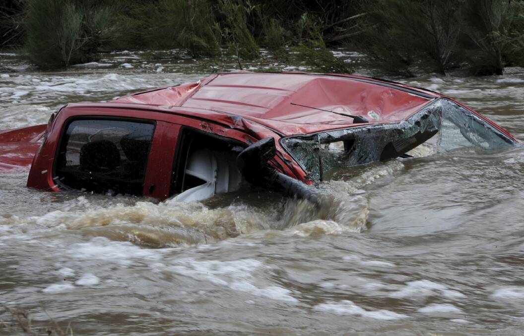 The driver of the twin cab four wheel drive vehicle died when it was swept away in Paddy's river. Photo: Graham Tidy