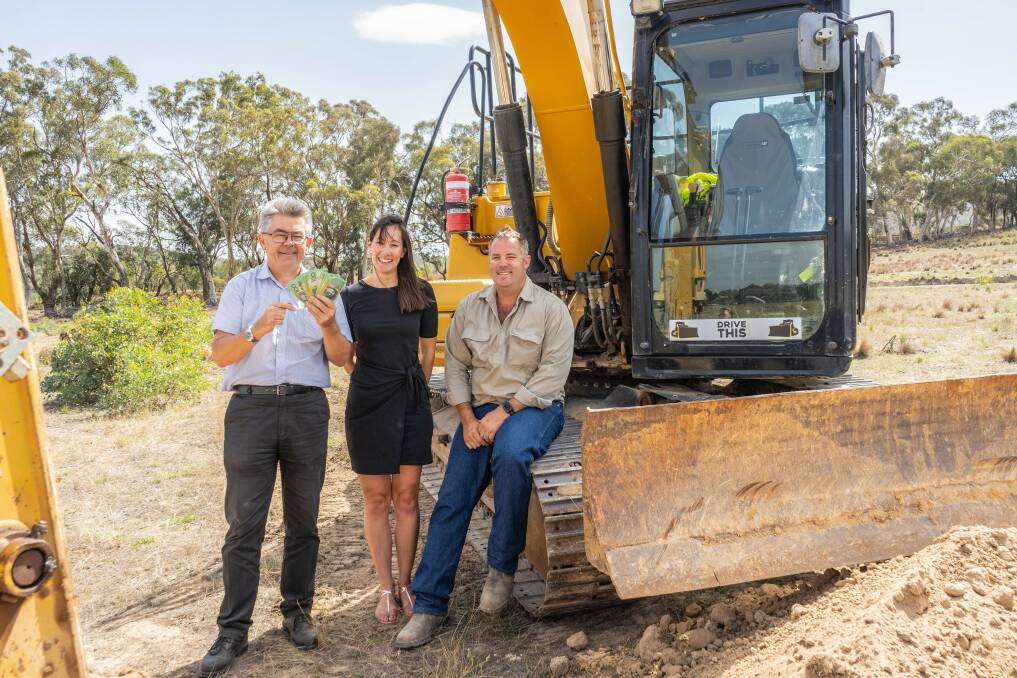 Royal Canberra Show chief executive Athol Chalmers launches the 'Dueling Excavators' competition with sponsors Yukari and Lee Carmody, of Drive This Canberra. The competition is part of a new-look main arena program at this year's Show. Photo: Samantha Taylor