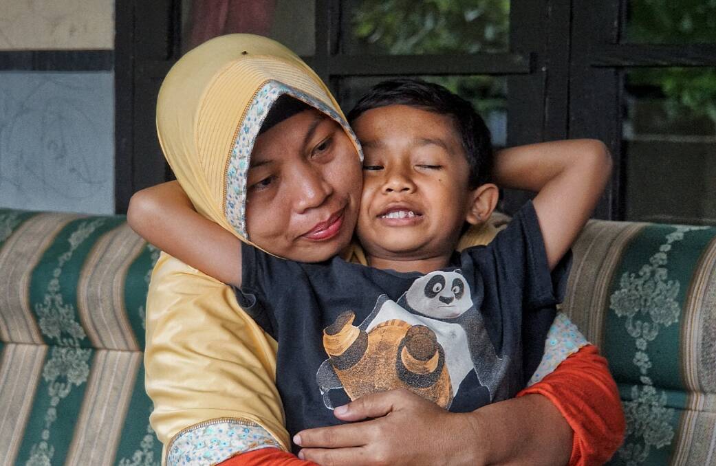 Baiq Nuril Maknun and her youngest son, seven-year-old Rafi. Photo: Amilia Rosa