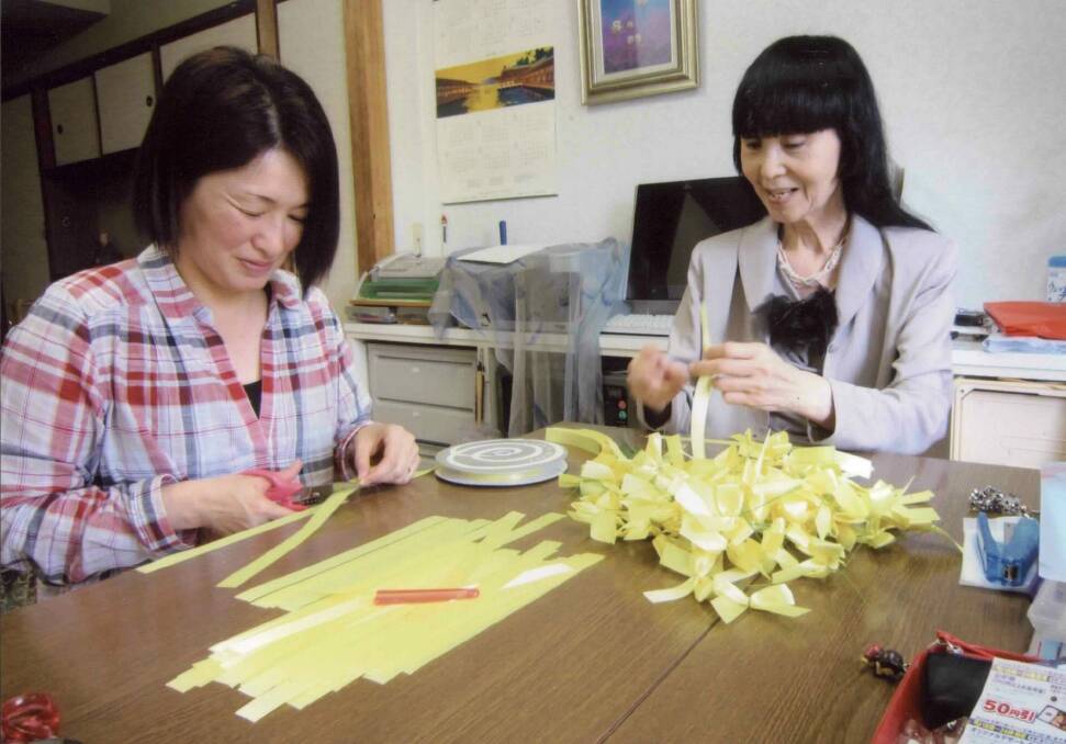 Hiroshima women make wattle-yellow ribbons to send to Canberra. Photo: ANBG