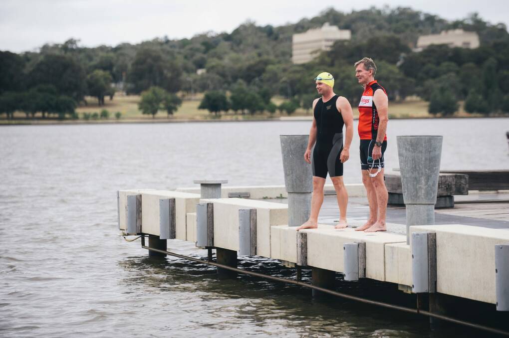 Triathlon ACT's Steve Hough and Craig Johns by Lake Burley Griffin are frustrated with the lasting community perception that Canberra's lakes are unsafe to swim in. Photo: Rohan Thomson