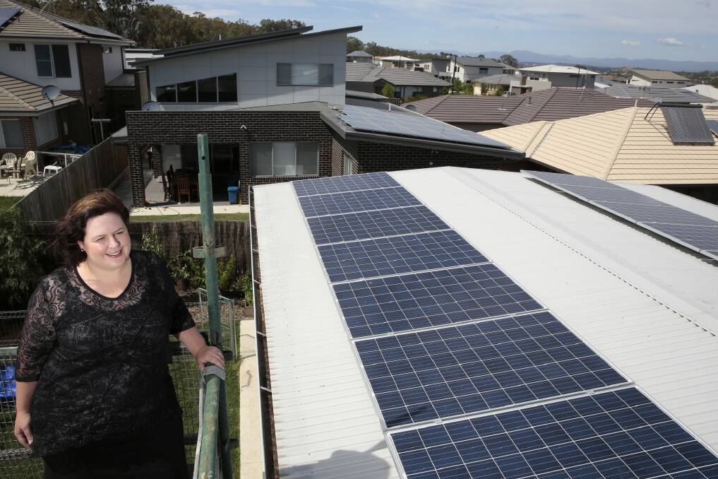 Rachael Turner of Forde with her 5.2kW solar power system that has a battery storage system, taking part in a battery trial launched by  ActewAGL and Panasonic. Photo: Jeffrey Chan