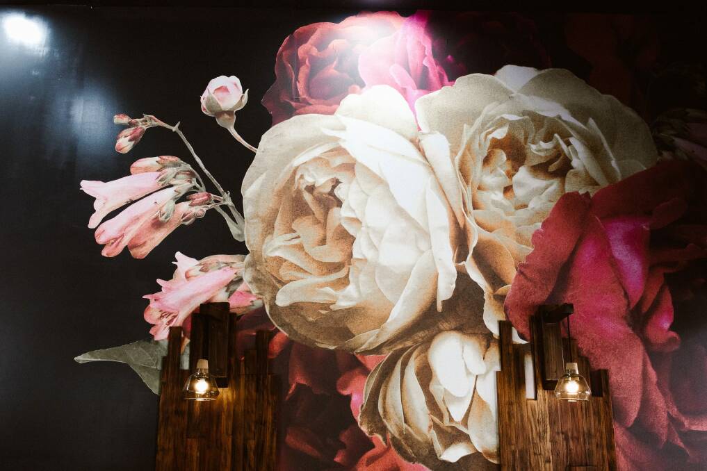This photo portrait of roses dominates a feature wall. Photo: Supplied