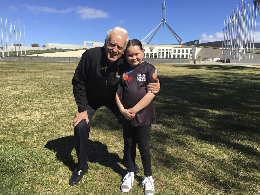 Today, Audrey (pictured with The Kids' Cancer Project founder Col Reynolds) is a healthy young girl heading to high school next year. Photo: Supplied