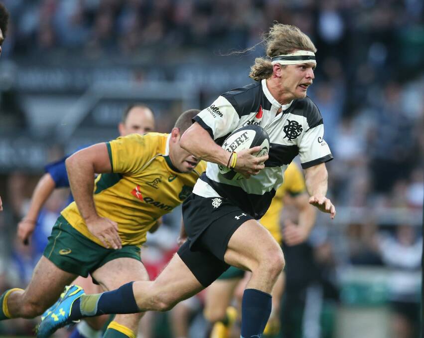 On the burst: Nick Cummins breaks clear to lead the Barbarians fightback. Photo: Getty Images