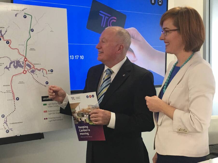 Ministers Mick Gentleman and Meegan Fitzharris with a map of four possible light rail routes for stage two. Photo: Kirsten Lawson
