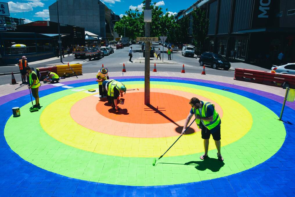 Members of the community paint the final touches on the rainbow roundabout on the corner of Elouera St and Lonsdale St in Braddon.  Photo: Rohan Thomson