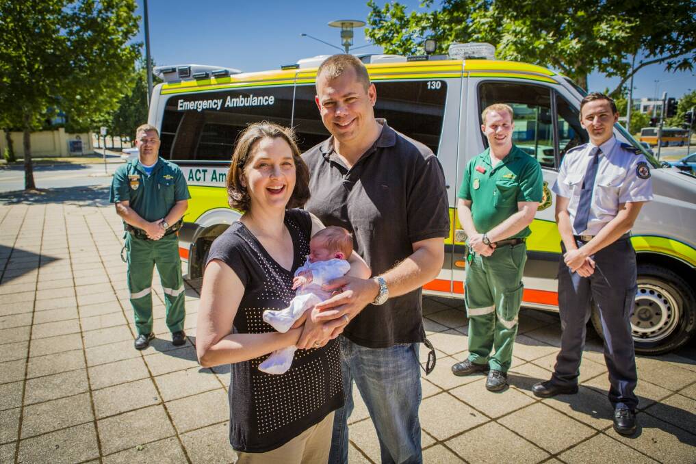 Calli and Chris Bowyer with 2-week-old Maisie, who was born on the side of Gunghalin Drive, reunite with their paramedic helpers. Photo: Jamila Toderas