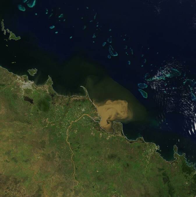 Summer flooding in north Queensland delivers significant freshwater runoff into the Coral Sea creating concerns over the impact to the adjacent Great Barrier Reef. Photo: USGS/NASA Landsat