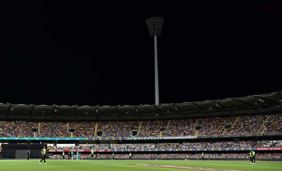 Spectators used their mobile phone camera lights to brighten the playing field after the stadium's floodlight went out. Photo: Darren England - AAP