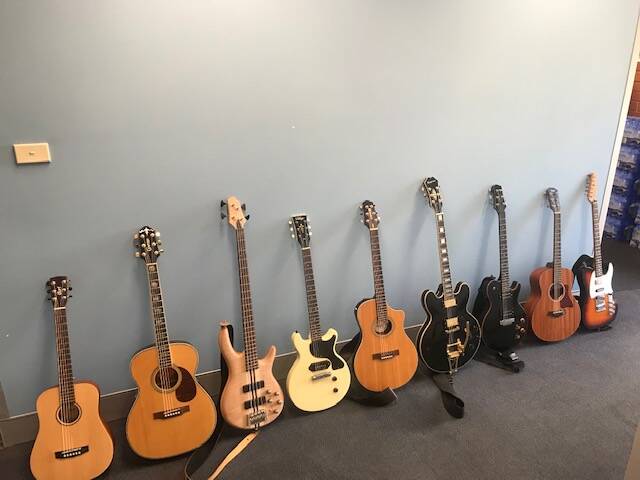 Nine guitars discovered by ACT Policing during a search of a Gungahlin home on Friday. The search also uncovered a cannabis cultivation operation at the premises. Photo: ACT Policing