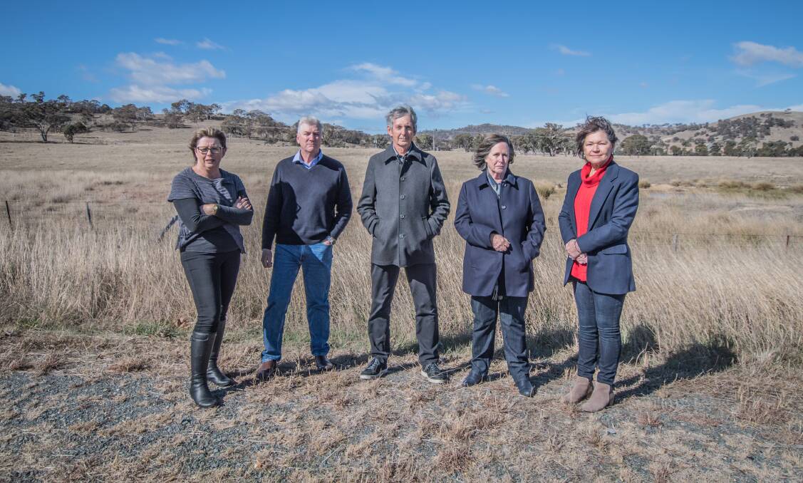 Googong residents who are opposing a cemetery being built at the Old Cooma Road site (from left) Beth and Geoff Smith, Brian and Joanna Hartfield and Wendy Hubbard.  Photo: Karleen Minney