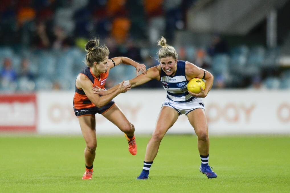 Ellie Brush pressures Melissa Hickey of the Cats. Photo: AAP