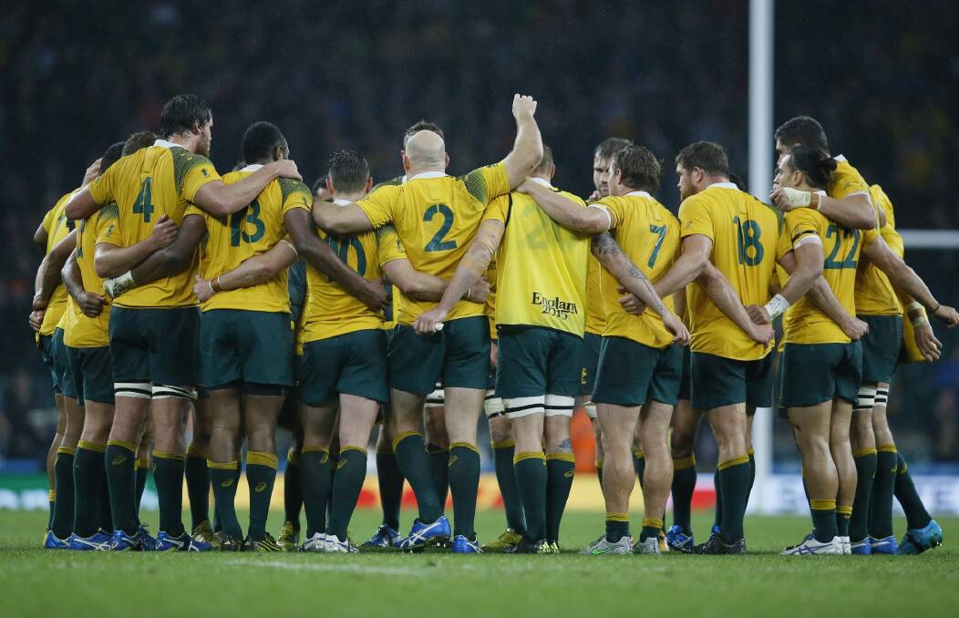 Australia players gather after the Rugby World Cup quarterfinal win over Scotland.  Photo: AP