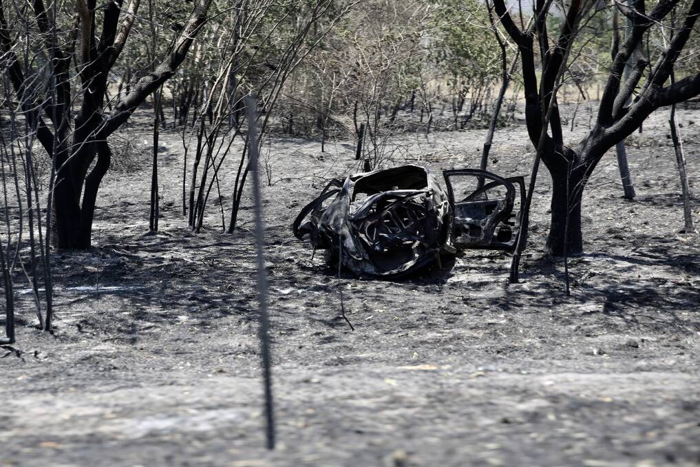 A burnt-out car in Kabra. Photo: Jack Tran/Office of the Premier