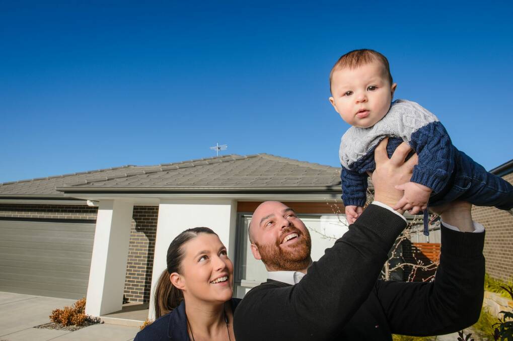 Sophie Victory, Nick Paine and five-month-old Oscar at home in Casey. They bought their four-bedroom house just over two years ago for $580,000. Photo: Sitthixay Ditthavong