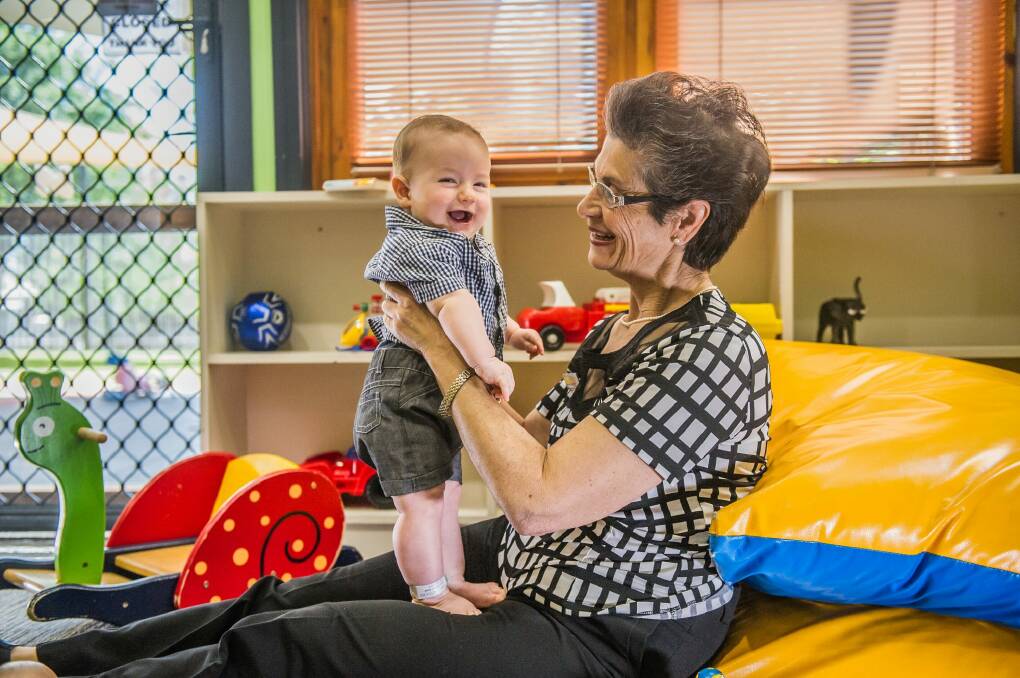 Canberra Mothercraft Society president Viola Kalokerinos with Noah Cool, six months, at the QEII Family Centre on Friday.  Photo: Karleen Minney