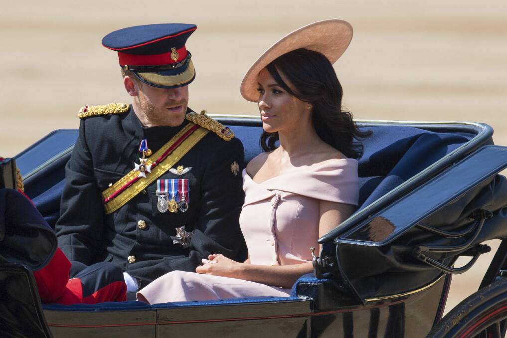 Prince Harry and Meghan, the Duchess of Sussex, ride in a carriage during the Trooping the Colours ceremony as the Queen celebrates her official birthday in London. Photo: PA/AP