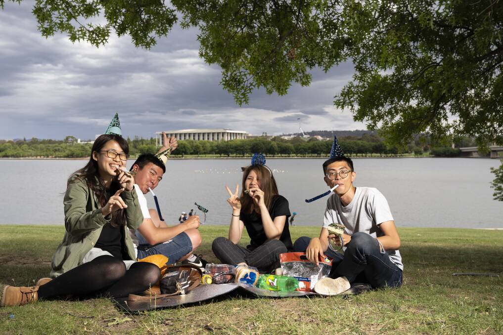 Mona Liu, Yu Li, Lou Liou and Jerry Wu, pictured above at Commonwealth Park, are ready to celebrate New Years Eve Photo: Lawrence Atkin