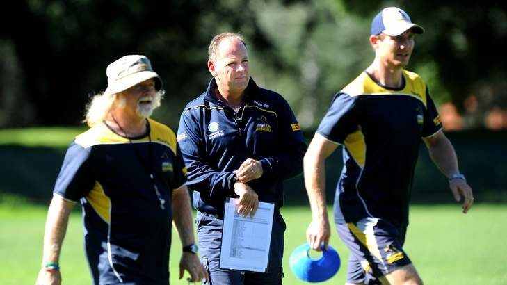 Brumbies coach Jake White (centre) with his assistant coaches Laurie Fisher and Stephen Larkham. Photo: Melissa Adams